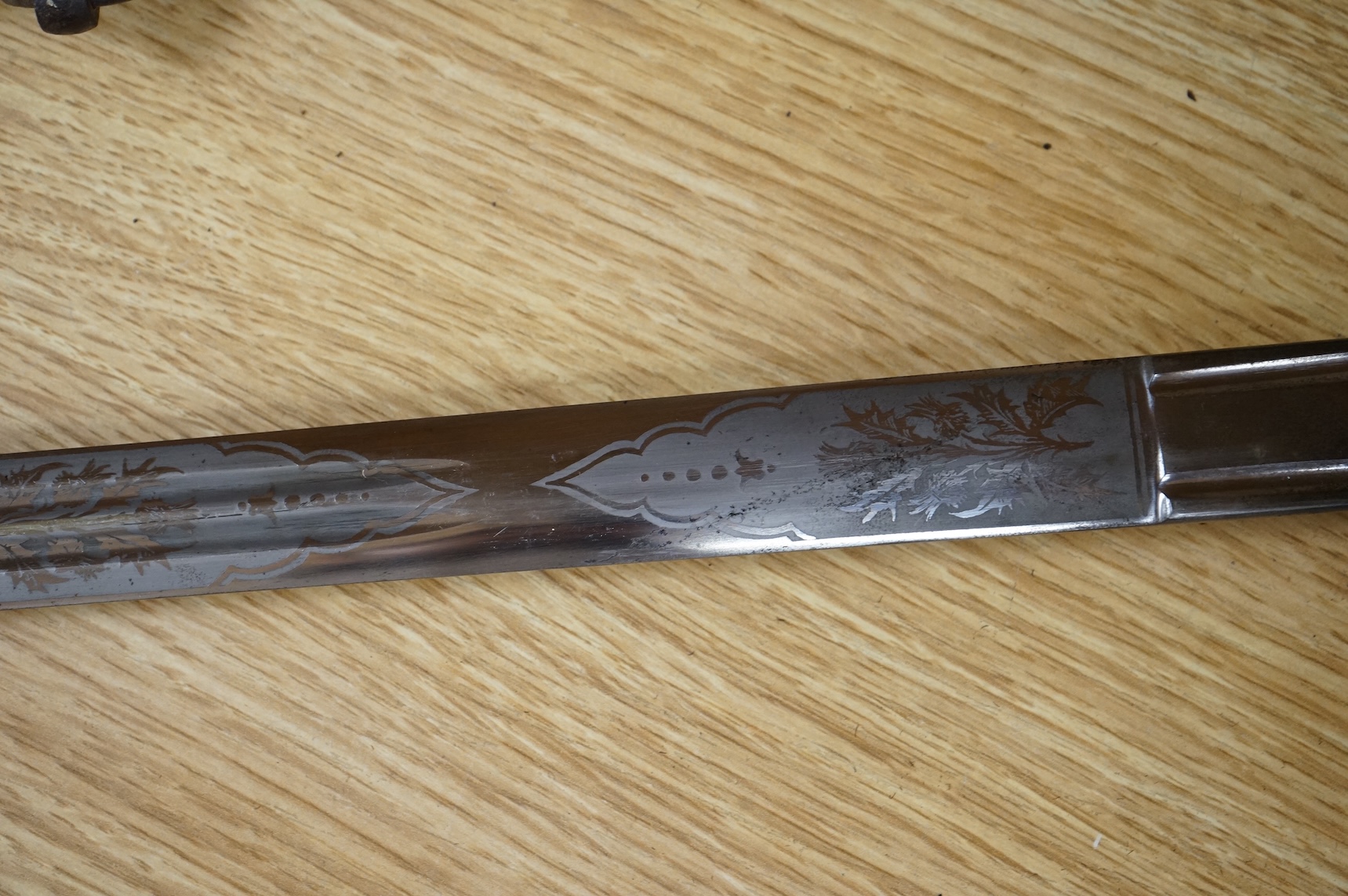 World War I Scottish infantry officer’s undress sword, etched and polished regulation blade with crowned GVR cipher and regulation cruciform hilt, in its steel scabbard